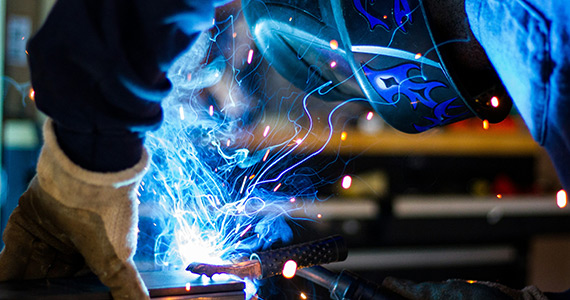 Man is welding the metal parts